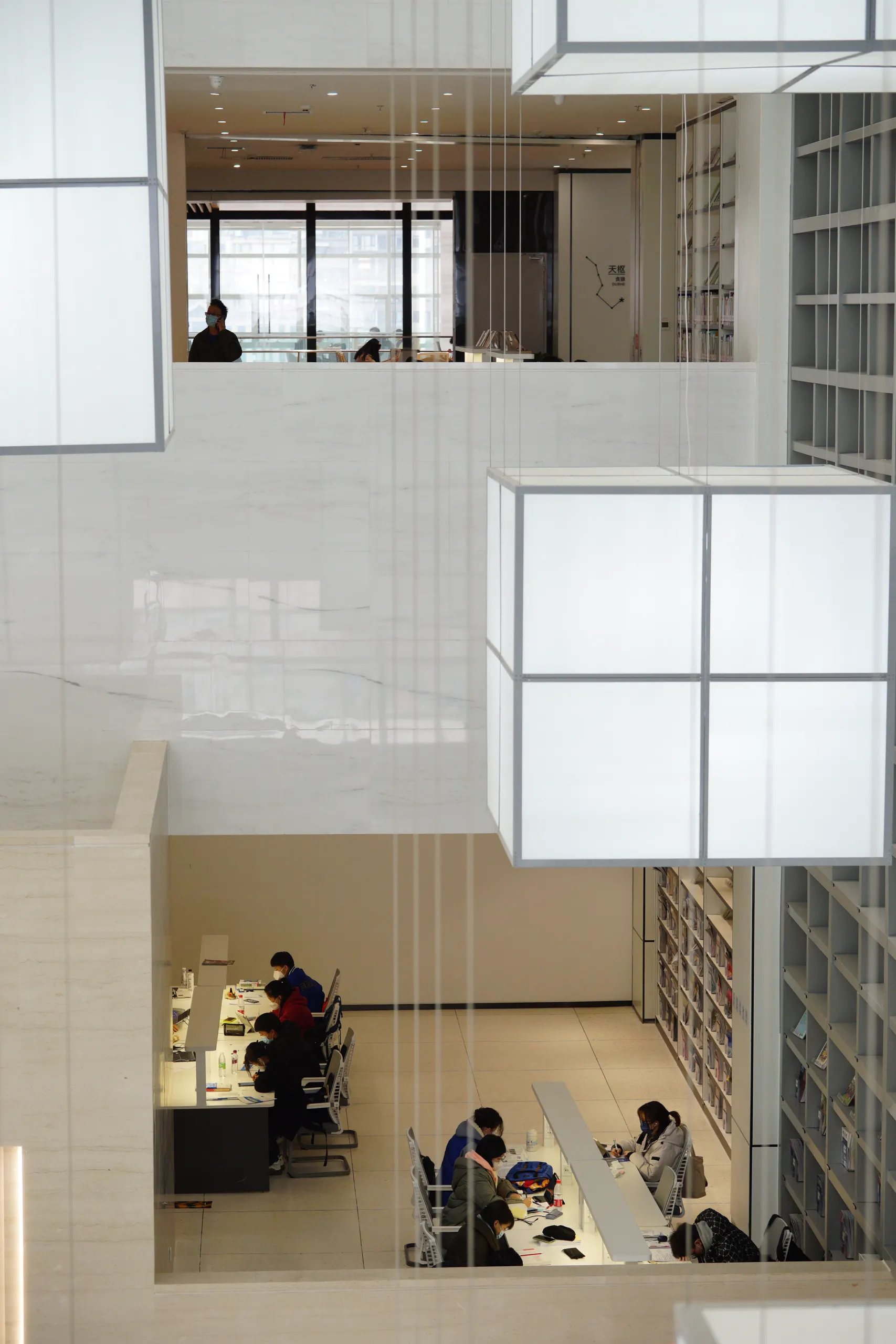 Modern multi-level workspace with people working at shared desks