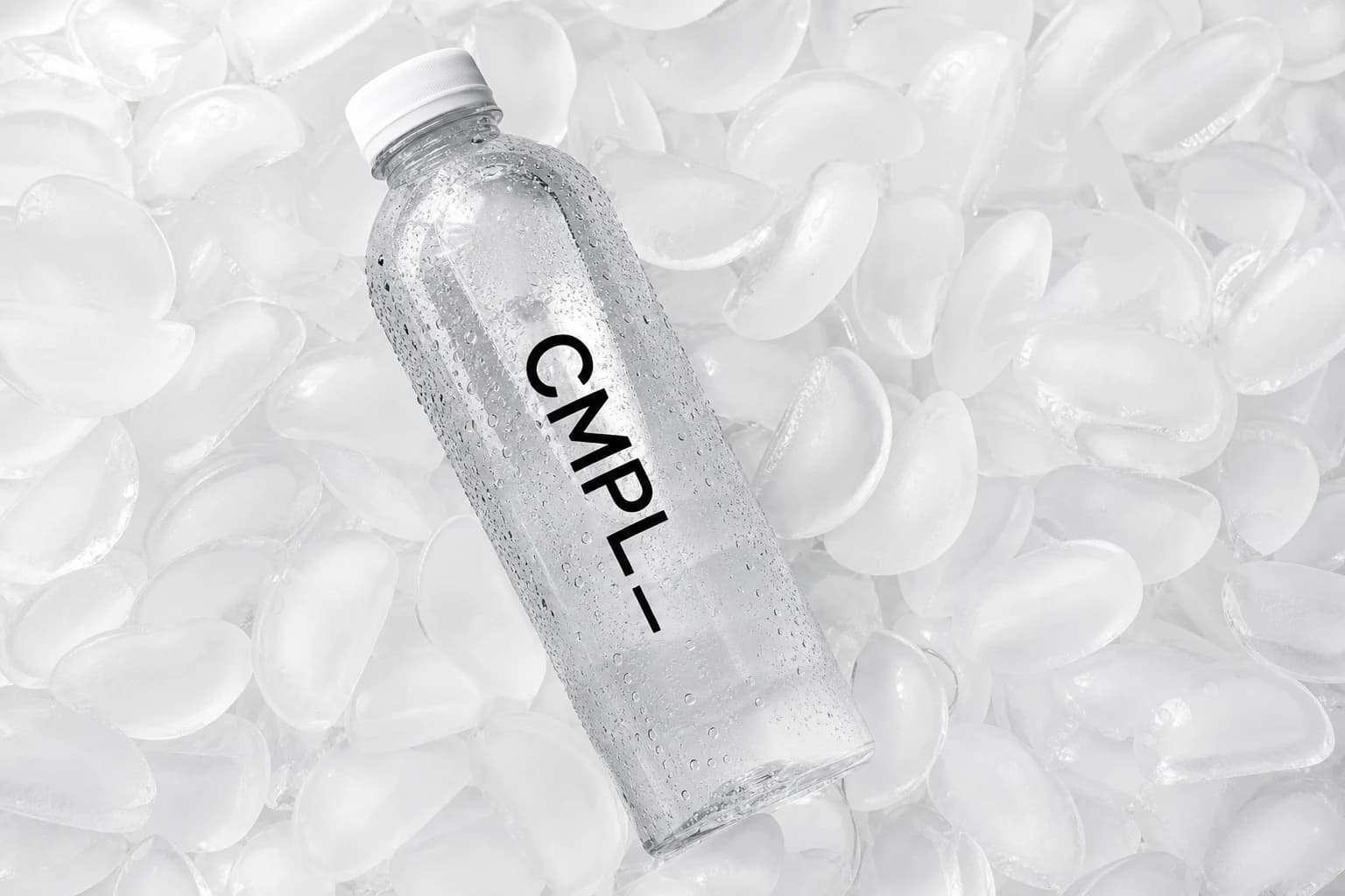 CMPL water bottle resting on clear ice